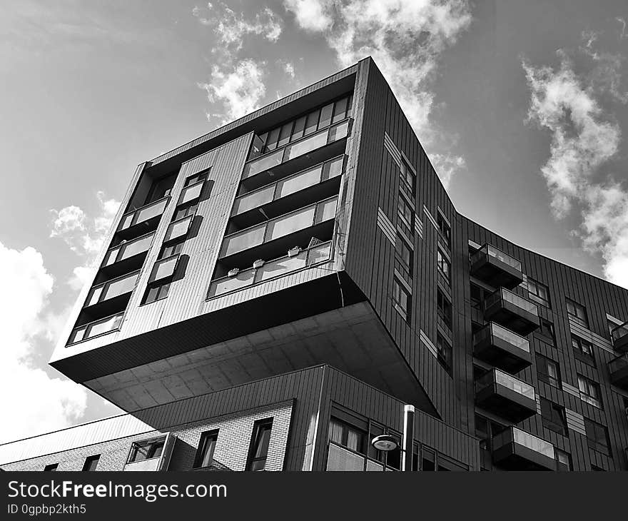 Facade of apartment block with balconies built on top of another but with unique cantilever design and with an unexpected bend (twist) on the upper floor. Facade of apartment block with balconies built on top of another but with unique cantilever design and with an unexpected bend (twist) on the upper floor.