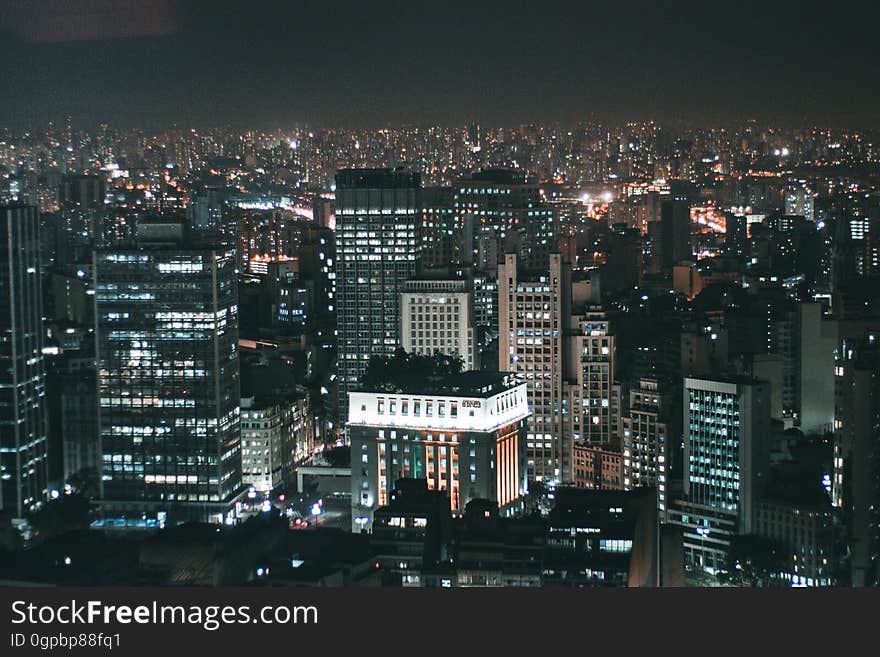 Aerial view over illuminated skyline of city at night. Aerial view over illuminated skyline of city at night.