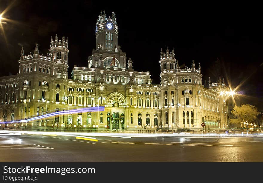 Historic architecture illuminated at night.