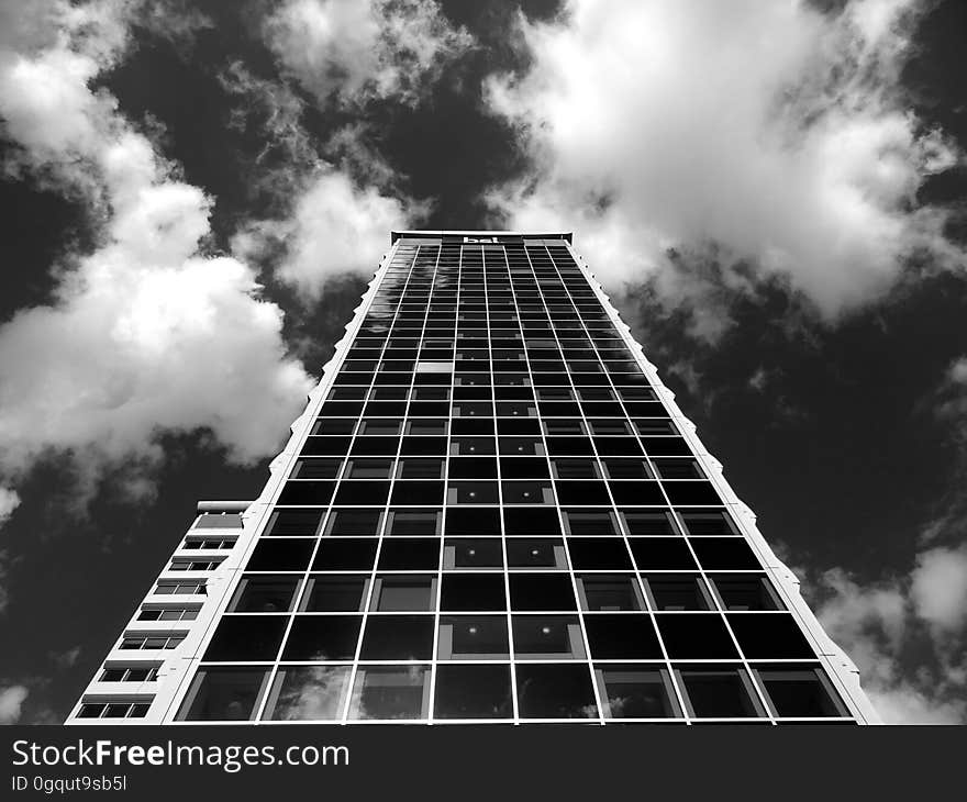 High rise modern building against cloudy skies in black and white. High rise modern building against cloudy skies in black and white.