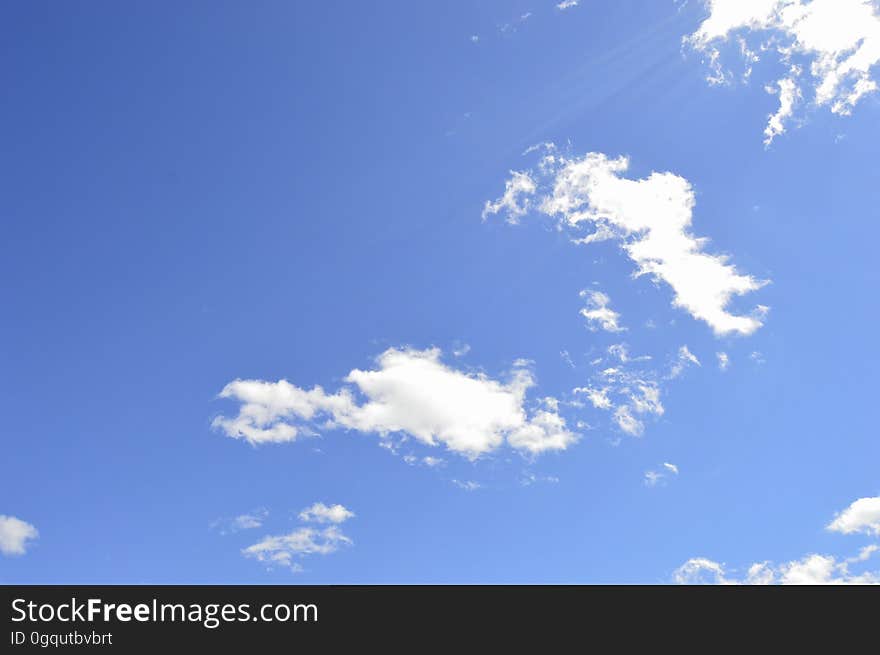 A sunny day with fluffy clouds floating in the sky. A sunny day with fluffy clouds floating in the sky.