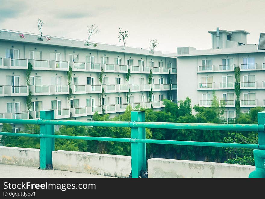 Railing on banister overlooking courtyard of modern apartment block. Railing on banister overlooking courtyard of modern apartment block.