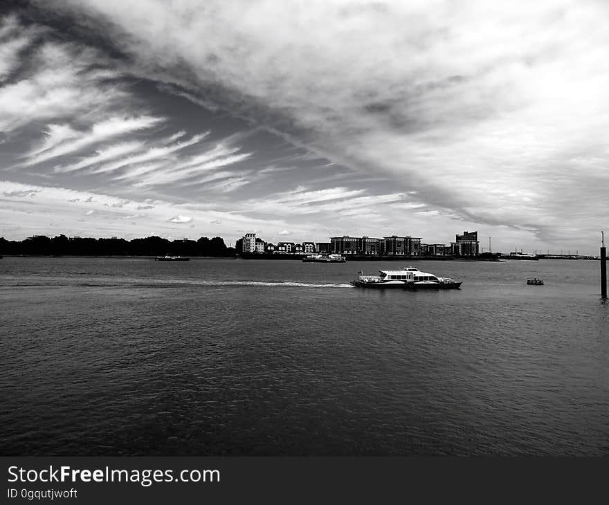 Barge on waters in black and white.