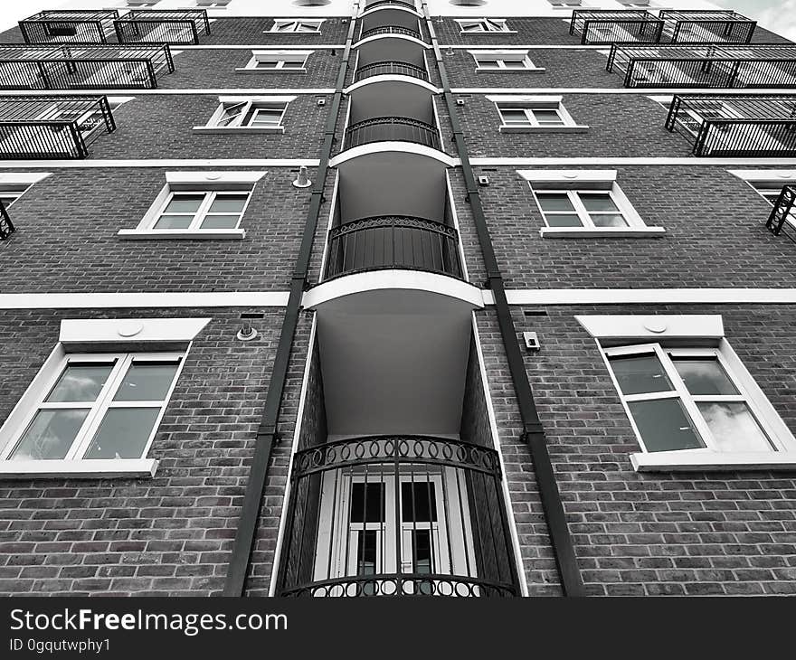 A monochrome of a residential building from a low angle.