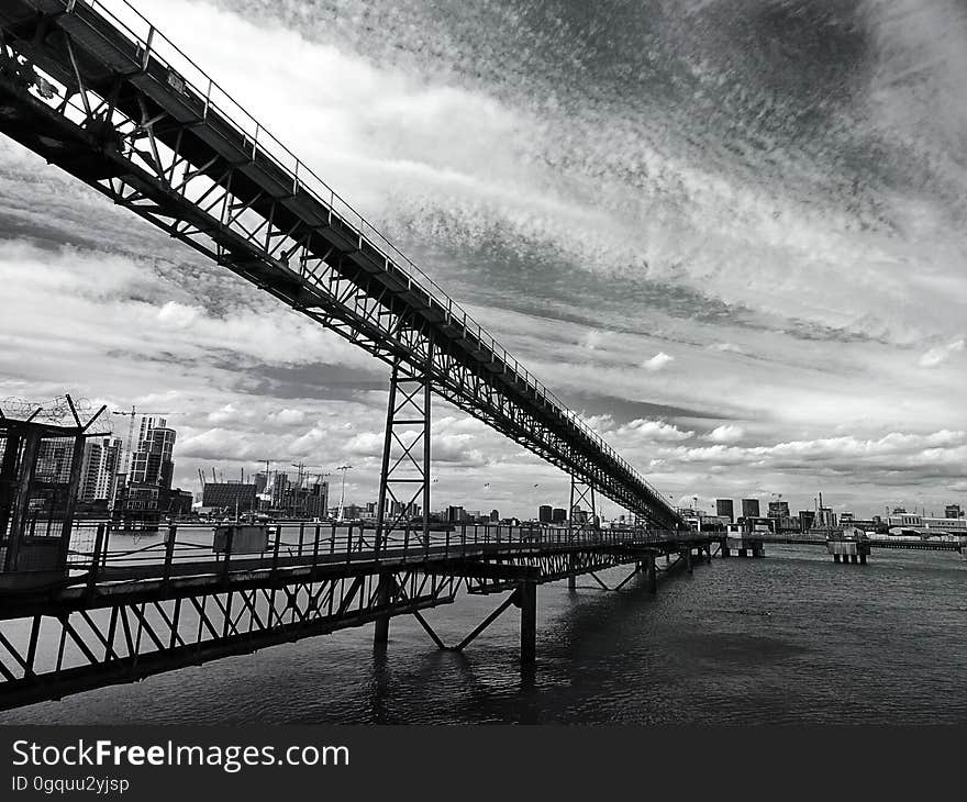 A monochrome of a steel bridge from a low angle. A monochrome of a steel bridge from a low angle.