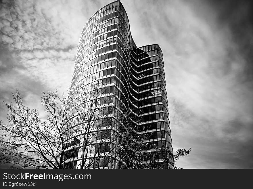 Low Angle View of Skyscrapers Against Cloudy Sky