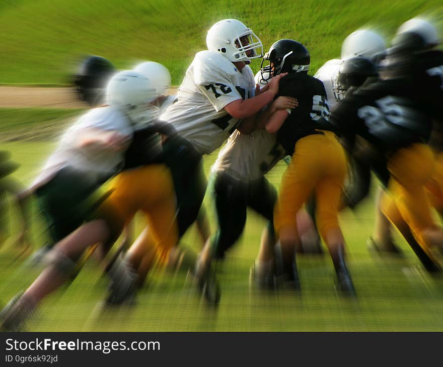 Men in White and Black Playing Football