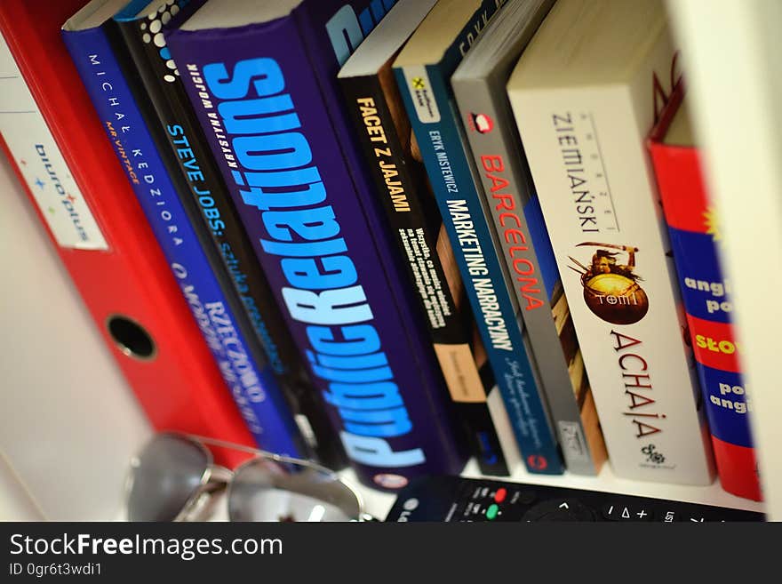 A bookshelf with books and other items. A bookshelf with books and other items.