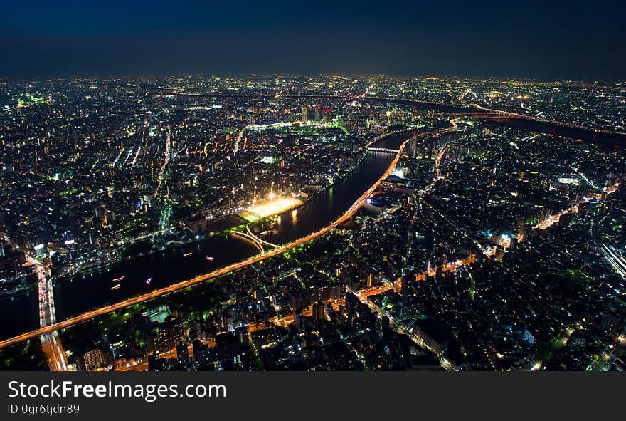 A modern metropolis with a river passing through it at nighttime. A modern metropolis with a river passing through it at nighttime.