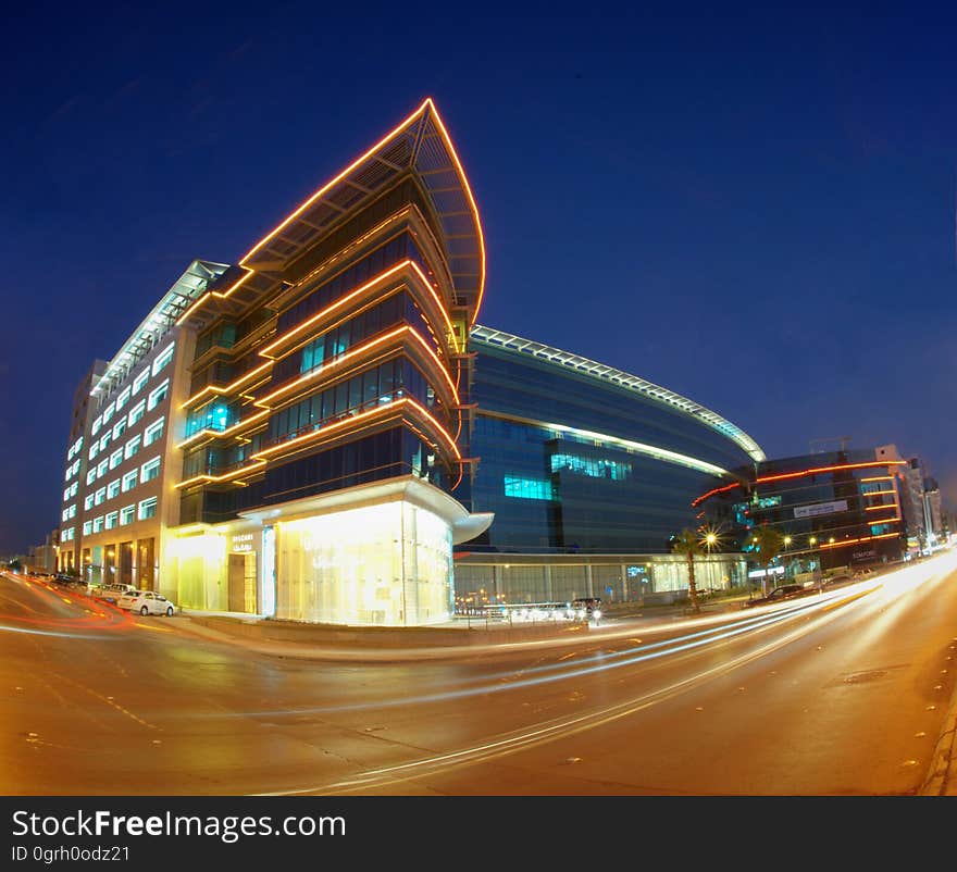 City buildings and streets with traffic at night. City buildings and streets with traffic at night.