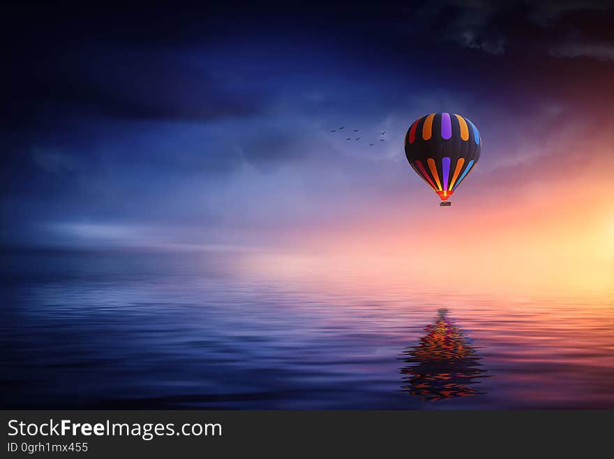 An illustration of a hot air balloon over water.