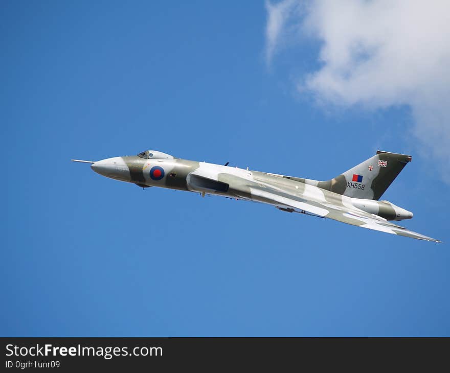 White and Grey Fighter Plane on Mid Air during Daytime