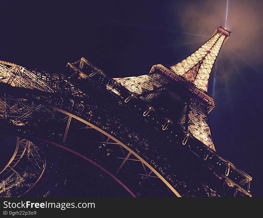 The Eiffel tower with lights in Paris, France, at night. The Eiffel tower with lights in Paris, France, at night.