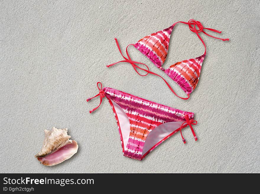 Orange Pink White Stripe Bikini Near Shell on Sand Beach