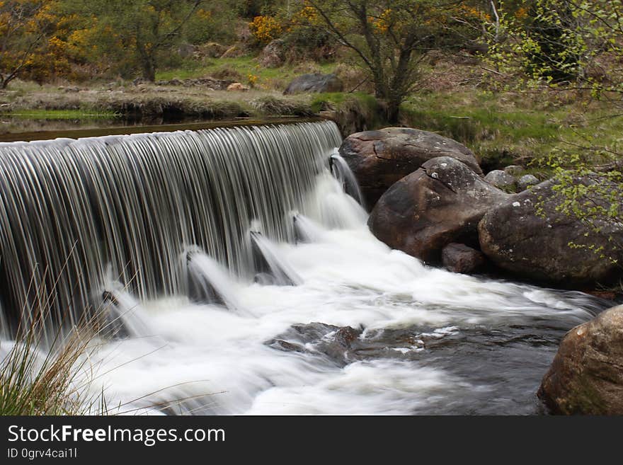 A river with a small cascade in forest. A river with a small cascade in forest.