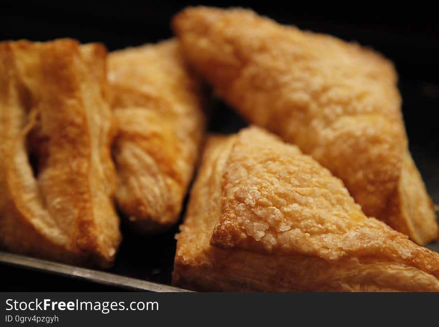 Apple turnovers or other similar pastries on a tray.