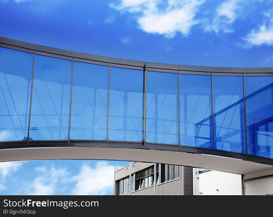 A modern skyway between modern buildings with blue sky on the background. A modern skyway between modern buildings with blue sky on the background.