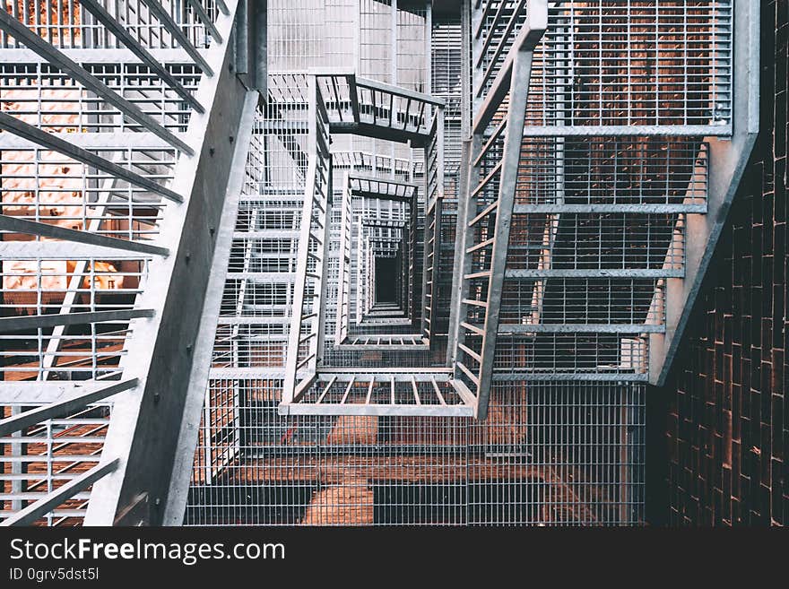 A view from the top of a metal stairwell.