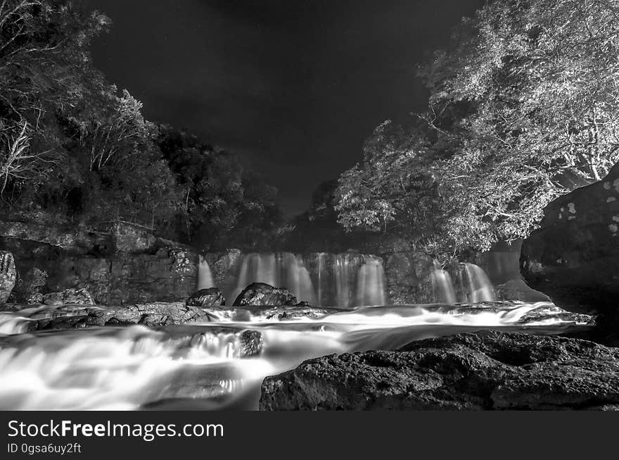 Greyscale Photo of Waterfall during Nighttime