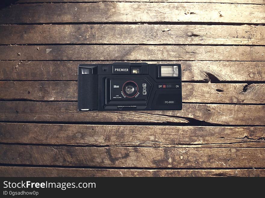 Classic retro style camera on wooden background.