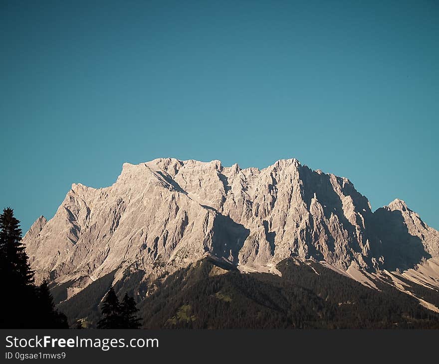 Rocky mountain range with blue sky background. Rocky mountain range with blue sky background.