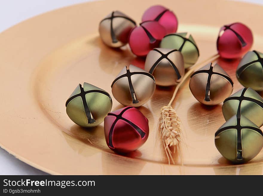 Red and green decorations on plate with ear of corn. Red and green decorations on plate with ear of corn.