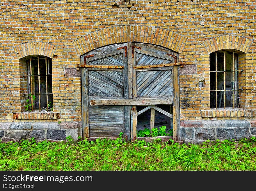 Rustic wooden door and windows in brick building. Rustic wooden door and windows in brick building.