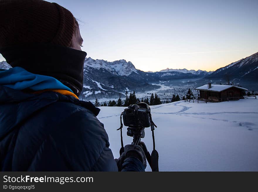 A photographer photographing a snowy landscape.