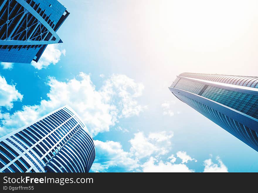 A low angle view between three high rise buildings.