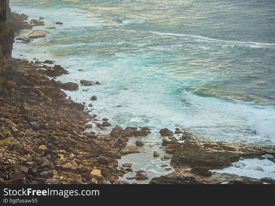 A rocky sea coast with waves coming ashore. A rocky sea coast with waves coming ashore.