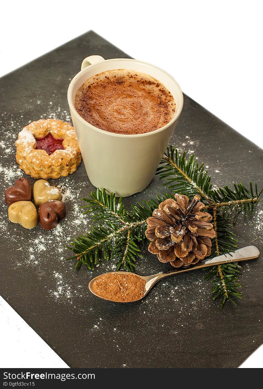 White Ceramic Mug With Brown Liquid and Pine Cone