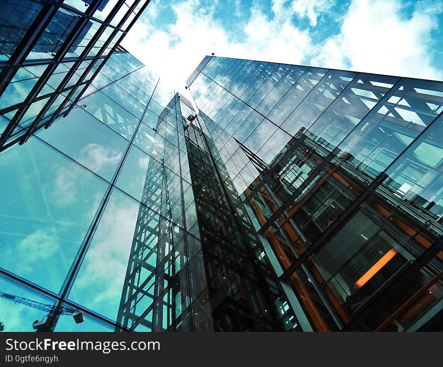 A low-angle view of a glass skyscraper.