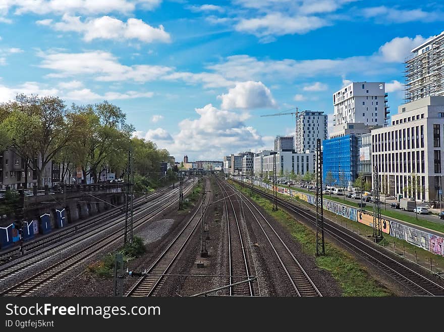 Train tracks running along high rise buildings in city. Train tracks running along high rise buildings in city.