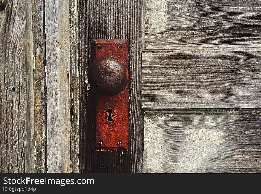 Close up of rusty door knob on rustic wooden door. Close up of rusty door knob on rustic wooden door.