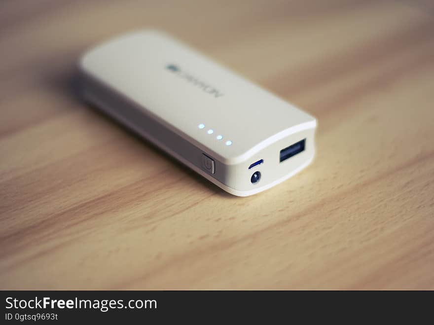 A portable power bank on a wooden background.