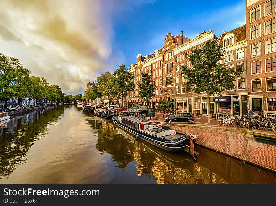 Houseboats along waterfront in city. Houseboats along waterfront in city.