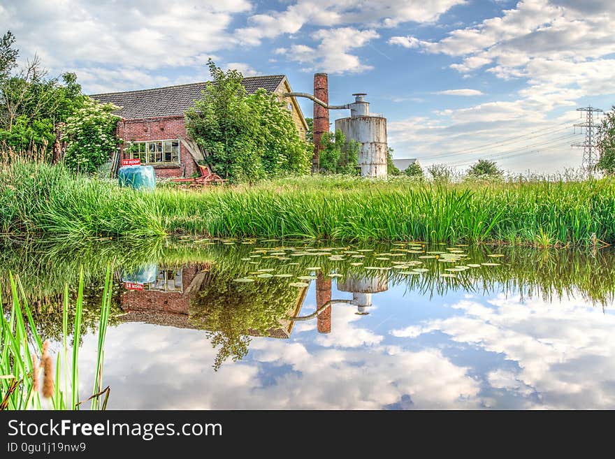 A barn is reflected in a pond. A barn is reflected in a pond.