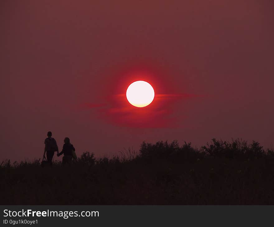 2 Person Walking Hand in Hand during Sunset