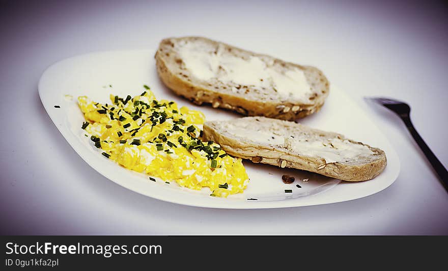 A plate with omelet and pieces of buttered bread. A plate with omelet and pieces of buttered bread.