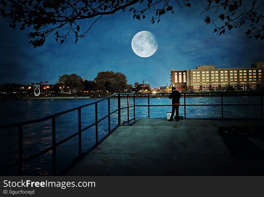 The moon on the sky over a city at nighttime. The moon on the sky over a city at nighttime.