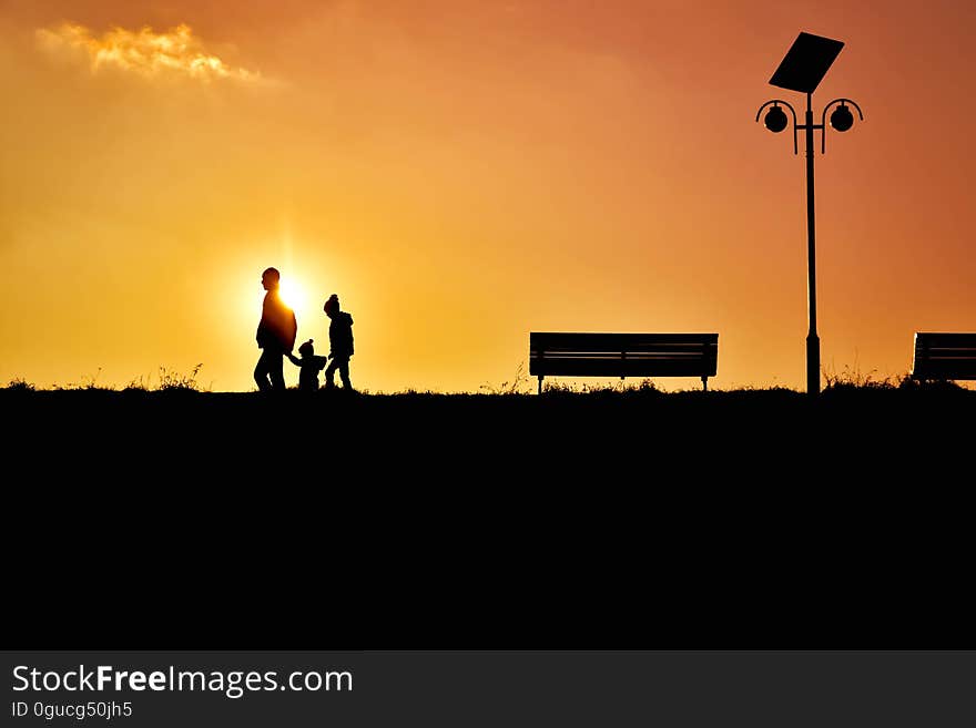 Men Riding Silhouette People on Street Against Sky during Sunset