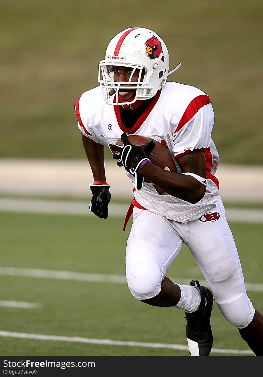 Football Player Running on Football Field