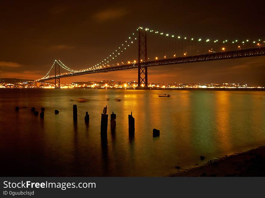 25 de Abril Bridge in Lisbon, Portugal, at night.