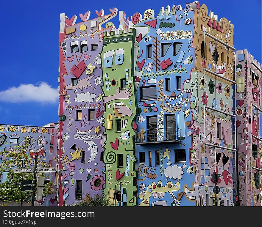 A building decorated with brightly coloured graffiti. A building decorated with brightly coloured graffiti.