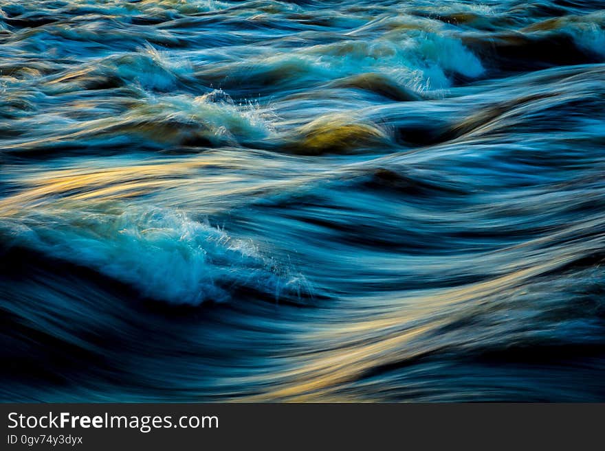 Turbulent waves photographed in long exposure.