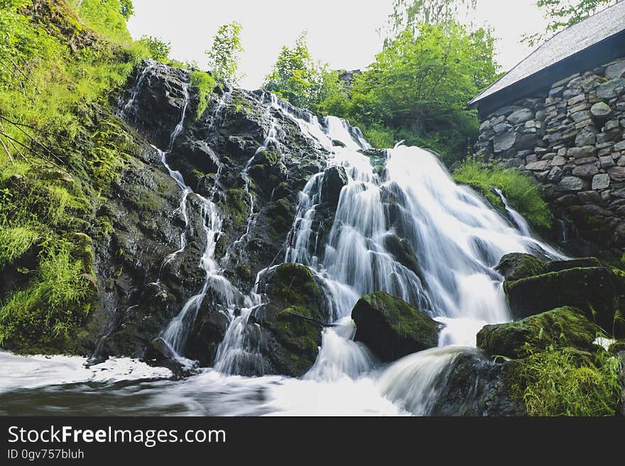 A waterfall cascading over rocks. A waterfall cascading over rocks.