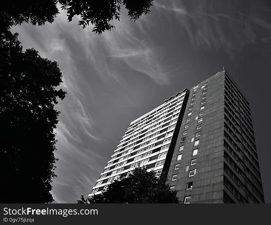 A black and white photo of an apartment block building.