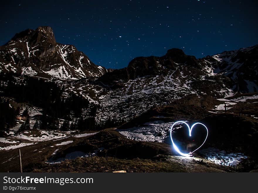 A long exposure with a heart light painting at mountains. A long exposure with a heart light painting at mountains.