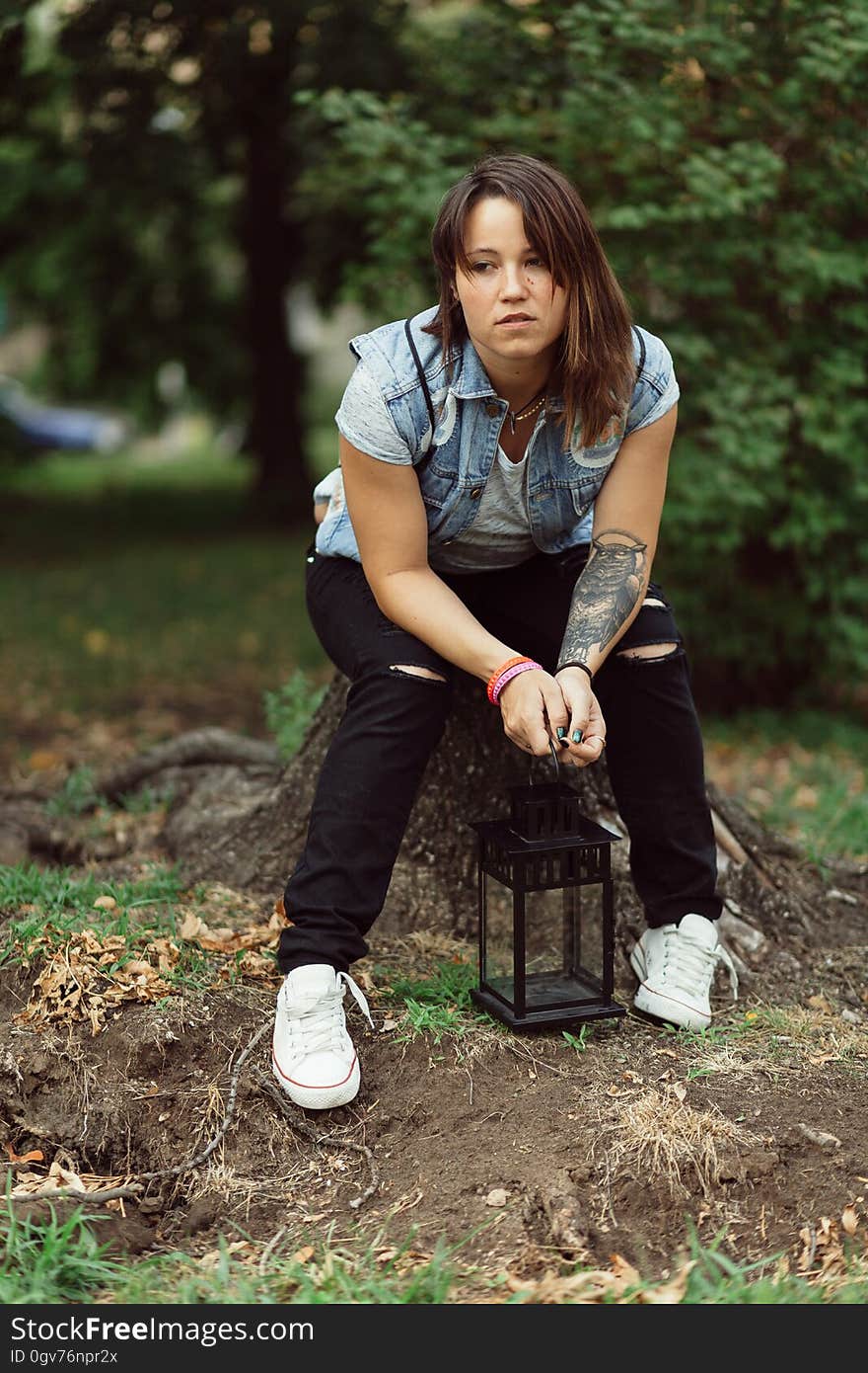 Woman Wearing Blue Denim Vest Sitting Tree Log