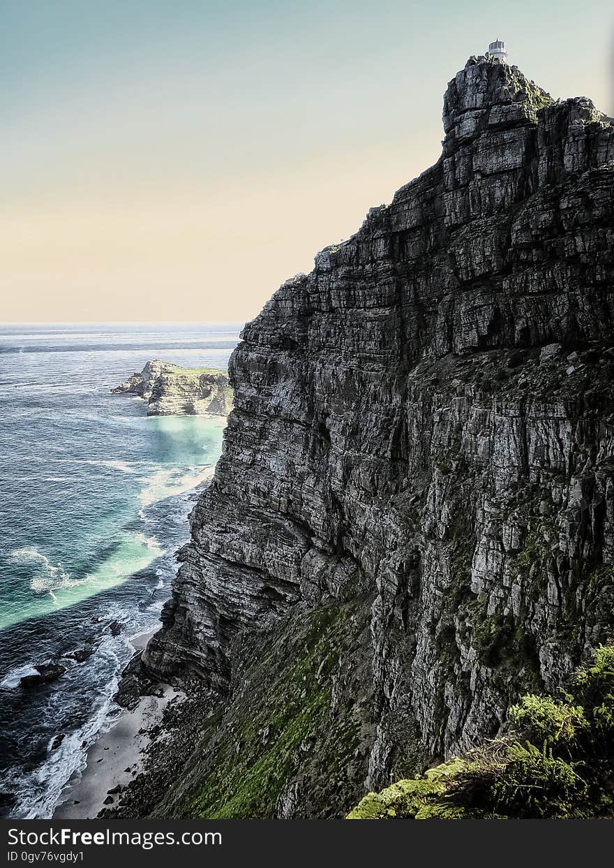 A rocky cliff at the sea shore.